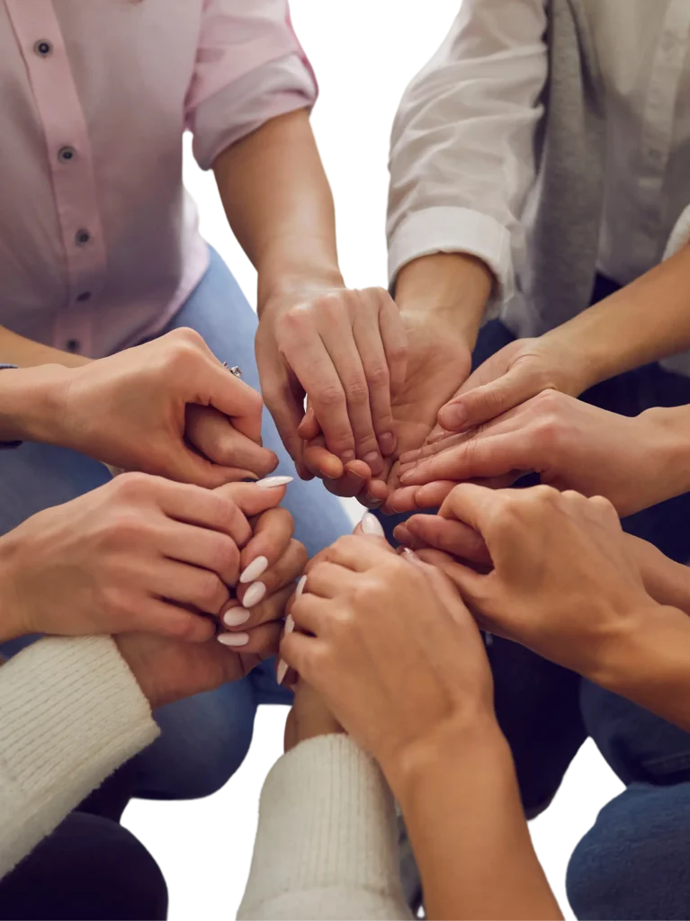 A supportive group holding hands in a circle to demonstrate unity and encouragement for mental health recovery in Hamilton, Ontario.