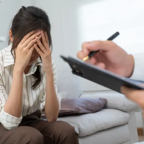 Individual receiving mental health support, guided by a professional.